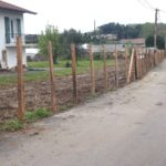 Pose de piquets d'acacia pour tenir la future clôture en brande de bruyère